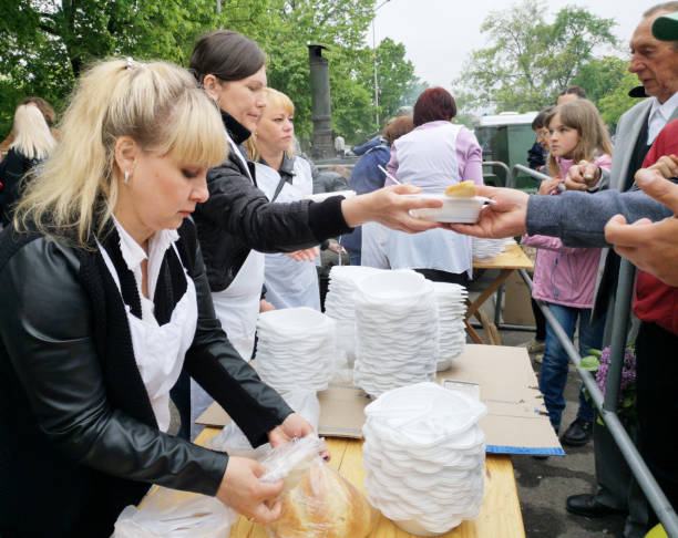 Nikopol, Ukraine - may, 2019: distribution of food to the needy, charity event Nikopol, Ukraine - may, 2019: distribution of food to the needy, charity event. Distribution of porridge in honor of the holiday of victory over Nazi Germany. Traditional cooking military porridge nikopol stock pictures, royalty-free photos & images