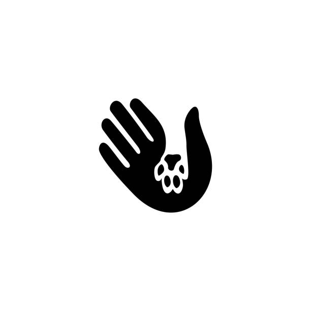 menschliche hand und haustierpfote in negativem raumvektorikonen illustration - pfote hand stock-grafiken, -clipart, -cartoons und -symbole