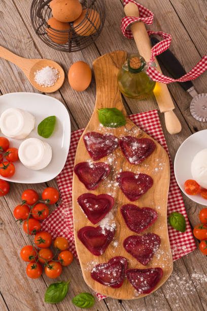istock Red heart ravioli with tomato, mozzarella and basil. 1152264205