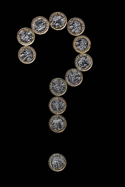 twelve british one pound coins arranged in the shape of a question mark on a black background showing the concept of financial questions. - two pound coin imagens e fotografias de stock