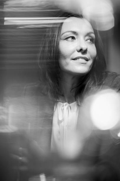 istock Woman black and white portrait through window 1152265723