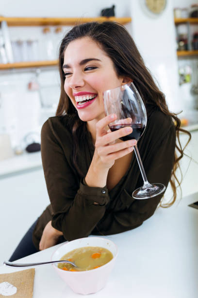 istock Beautiful young woman drinking some wine at home. 1152267400