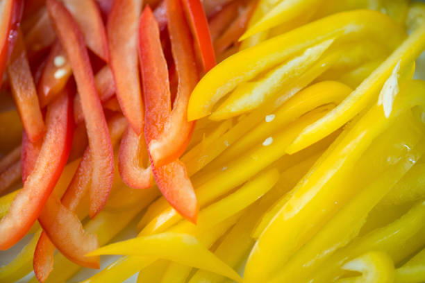 sliced yellow and red  bell pepper fruit closeup selective focus