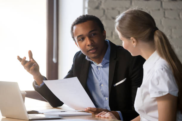 istock Boss interviewing female candidate, client and manager negotiating 1152268800