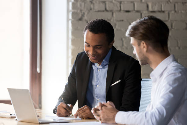 istock Diverse business partners after successful negotiations signing contract 1152268813