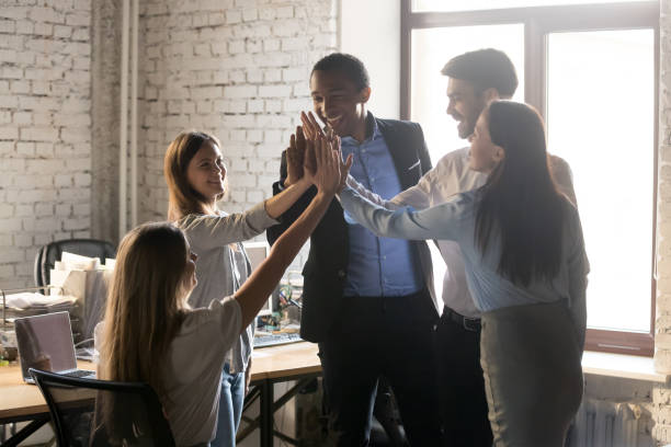 istock Happy multinational coworkers giving high five celebrating great teamwork result 1152268834
