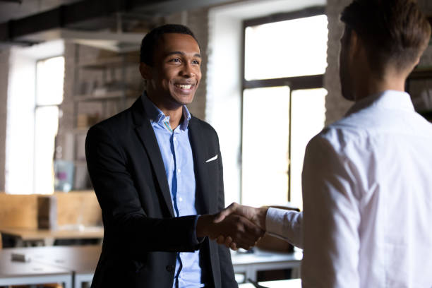 istock Boss shaking hands greeting new employee or company client 1152268842