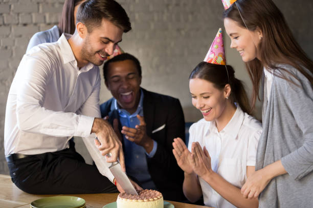 istock Birthday boy holding knife cut the cake presented by colleagues 1152268876