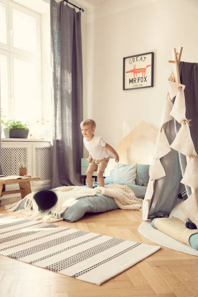 istock Boy jumping on a mattress in a cozy playroom interior 1152268892