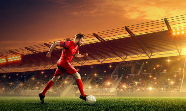 istock Soccer player in action. Night soccer stadium. 1152272011