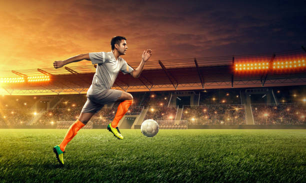 istock Soccer player in action. Night soccer stadium. 1152272019