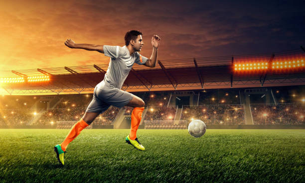 istock Soccer player in action. Night soccer stadium. 1152272022