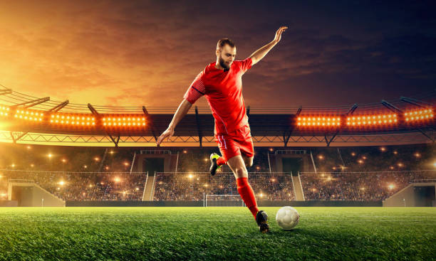 istock Soccer player in action. Night soccer stadium. 1152272032