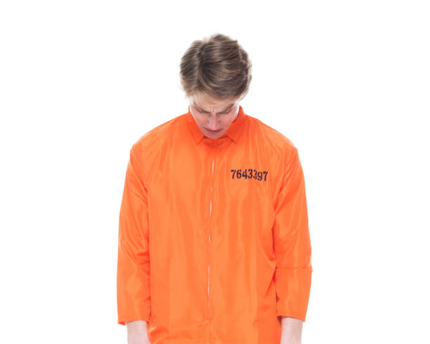istock Male prisoner wearing orange jumpsuit 1152282032