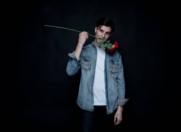 istock Attractive man is holding a rose 1152282226
