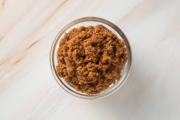istock Brown sugar isolated in glass bowl, over styled marble background. Top view, copy space. 1152282274