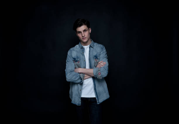 istock Good looking man wearing a button down shirt in front of black background 1152282329