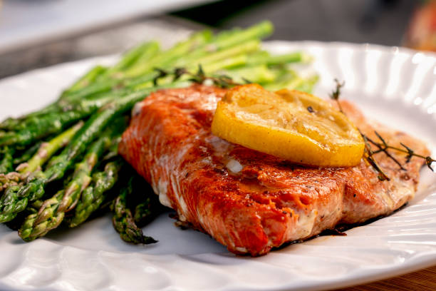 istock Low Carb Salmon Filet with Lemon Slices Plated With Asparagus 1152284389