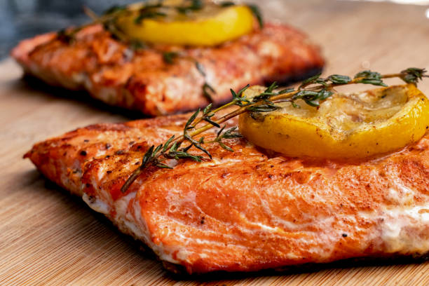 istock Low Carb Salmon Filet with Lemon Slices On A Wood Cutting Board 1152284974