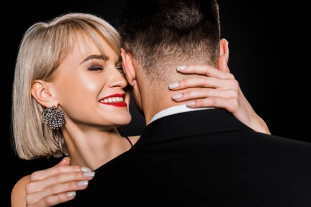 istock happy young woman hugging man isolated on black 1152285376