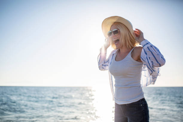 istock Woman watching sunset by the sea 1152287005