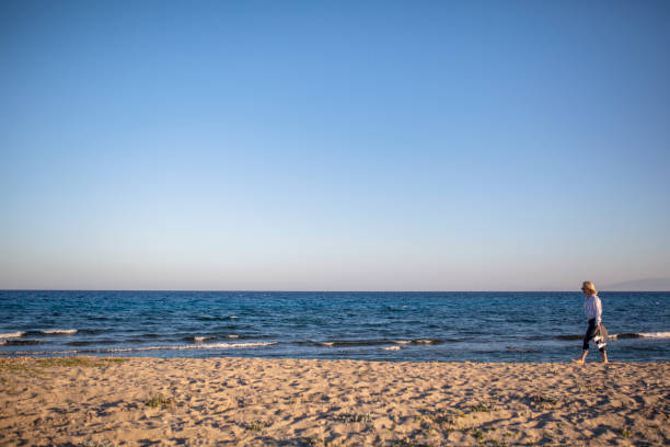 Woman watching sunset by the sea