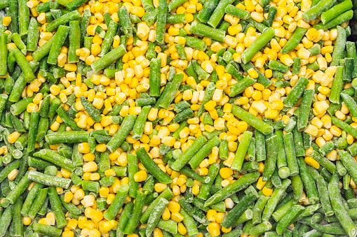 Frozen organic sweet corn and green beans. Healthy food concept, cooking background, close up, top view