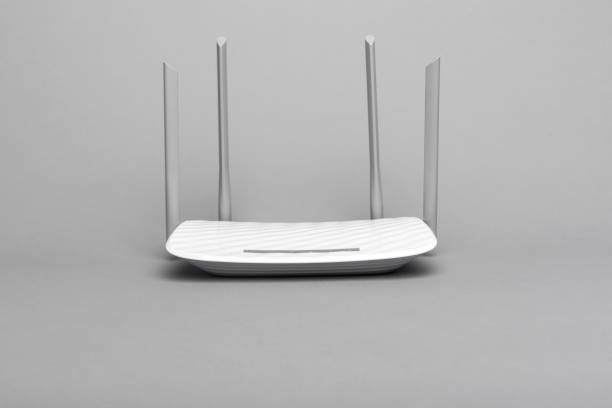 istock White modern Wi-Fi router with four antennas on gray background. 1152289849