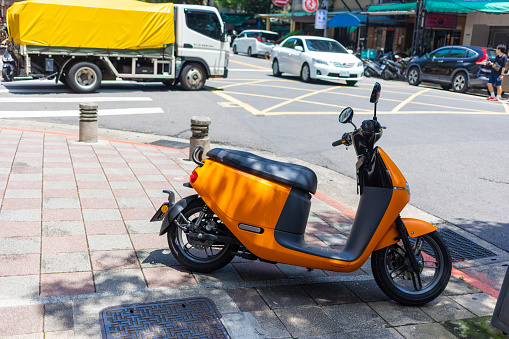 Taipei, Taiwan - May 5, 2019: Electric scooter parked on the footpath in Taipei