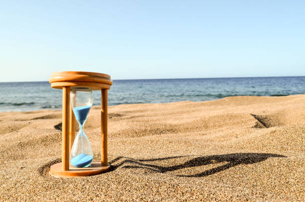 istock Hourglass Clock on the Sand Beach 1152299022