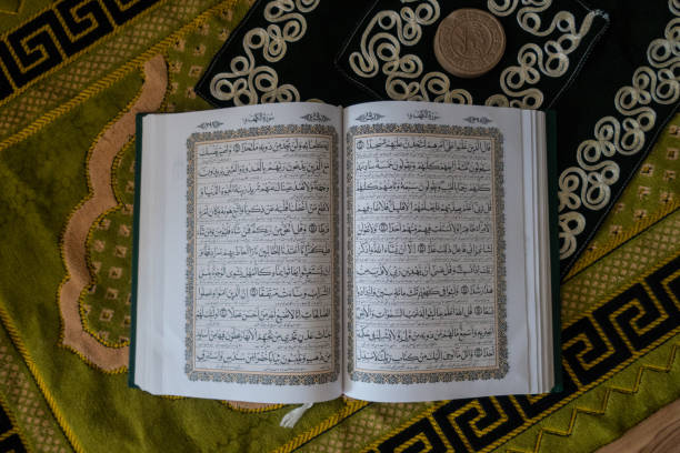 istock The Holy Quran over Muslim Prayer Carpet, Iran 1152301700