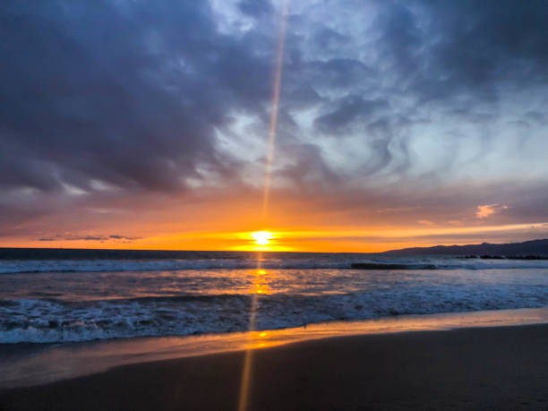 istock Sunset over the pacific ocean under storm clouds in Venice, CA 1152303247
