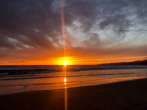 istock Sunset over the pacific ocean under storm clouds in Venice, CA 1152303259