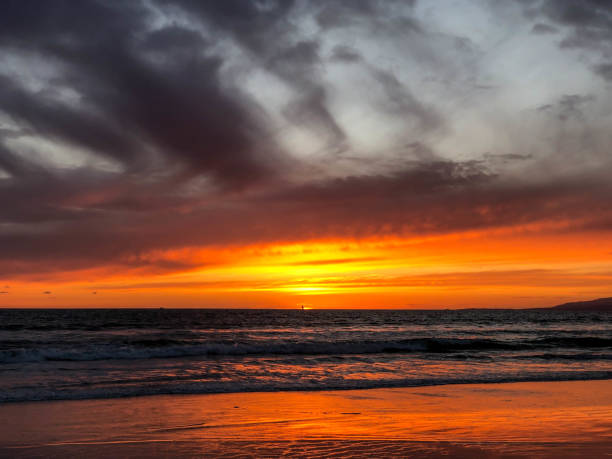 istock Sunset over the pacific ocean under storm clouds in Venice, CA 1152303267