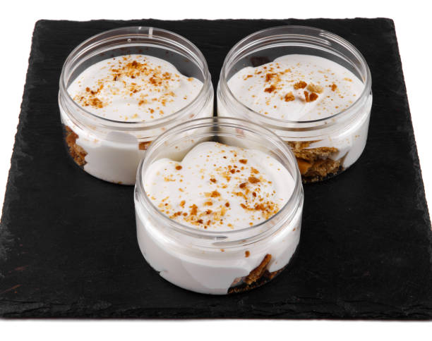 istock Honey cheesecake dessert in a jar on a black stone plate on a white background 1152306669