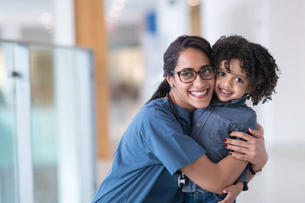 istock Female doctor hugging her toddler patient 1152310034
