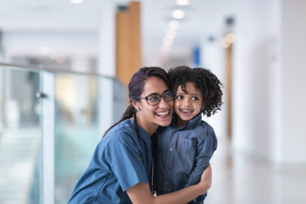 istock Female doctor hugging her toddler patient 1152310035