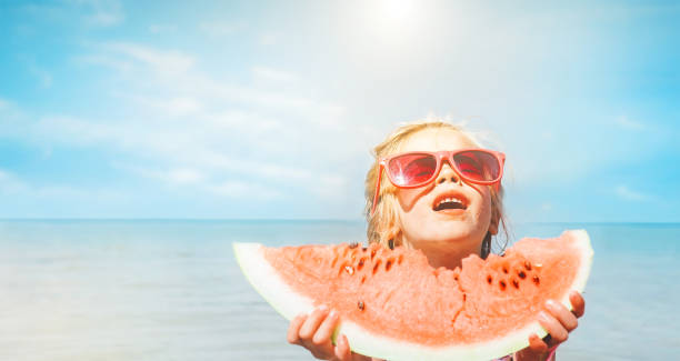 istock Little girl with big watermelon segment funny seside portrait 1152310057