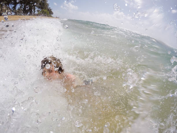 istock Child playing in the surf 1152310081