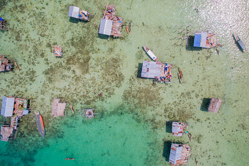 Marigot, Collectivity of Saint Martin / Collectivité de Saint-Martin, French Caribbean: sand and beach pier with deckchairs and the French flag - Marigot bay