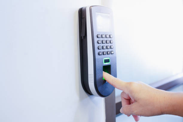 istock employee scanning fingerprint to record working time 1152315316
