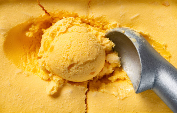 istock top view mango flavor ice cream ball and spoon close up 1152315462
