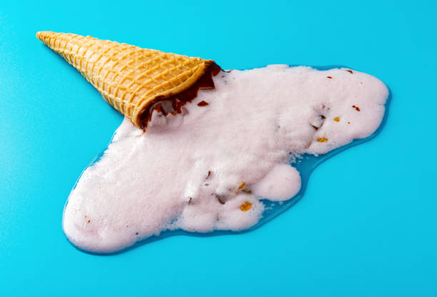 istock side view peanut ice cream cone melted on blue background 1152316117