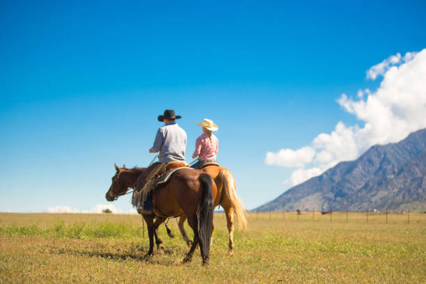 istock Ranchers couple horseback riding 1152318244