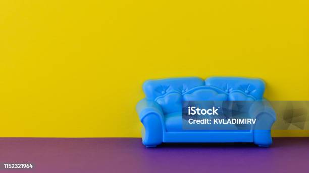 Beautiful Blue Sofa On The Purple Floor At The Yellow Wall A Sample Of Beautiful Furniture For The House Stock Photo - Download Image Now