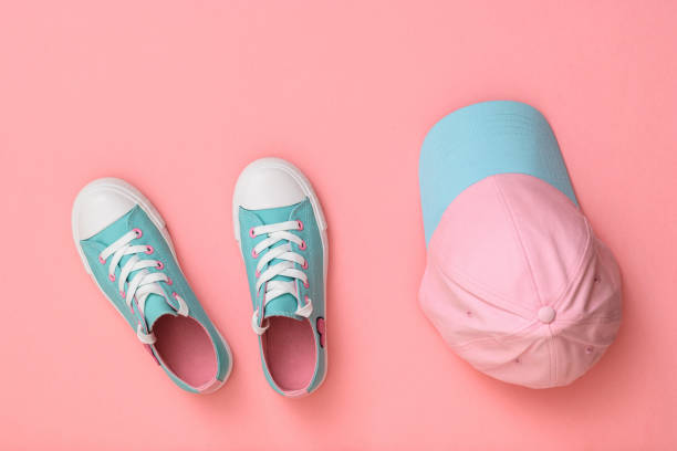 istock Turquoise shoes and turquoise cap on a pink background. Flat lay. 1152321975