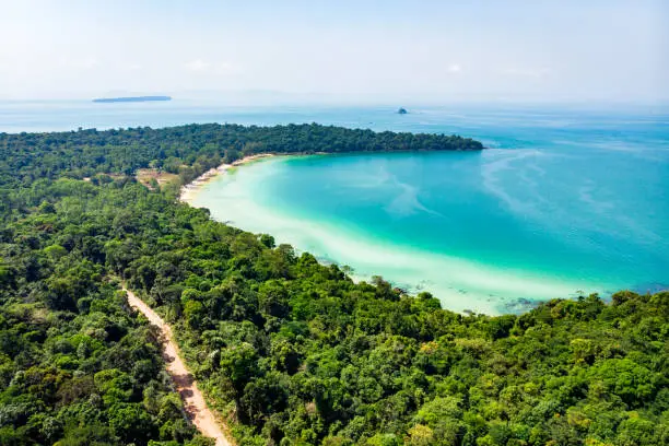long beach in tropical paradise snake island near sihanoukville cambodia. Top view of a beautiful tropical island with dense forest or jungle.