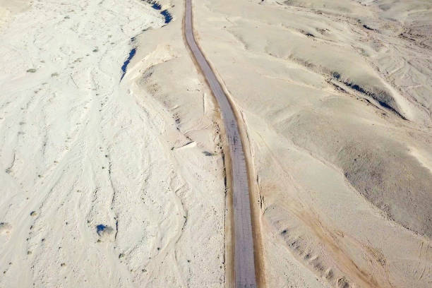 istock Old Desert road with cracked asphalt 1152329416