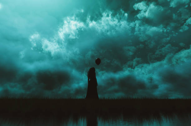 A silhouetted witch stirs a potion in a cauldron against a backdrop of a rising full moon and an orange and purple Halloween sky.