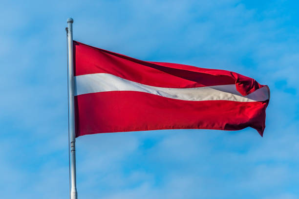 istock Red and white streaming flag of Latvia State 1152330804